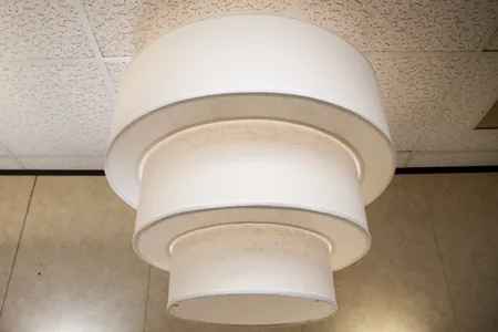 Three-tier pendant lampshade with ring-shaped donut diffusers between the tiers